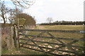 Minting: a post-coded gate and a hay rack by the road to White House Farm