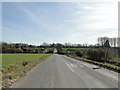 The road into Aspall drops into the valley and up the other side