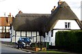 Thatched cottage and village pump in Quainton