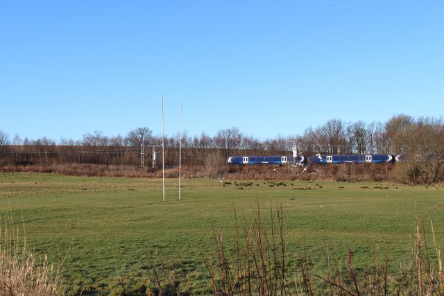 Train passing playing fields in Bishopton