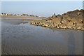 Me and my shadow looking across beach to shingle from edge of rock island