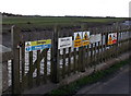 Danger signs on a riverbank fence, Highbridge