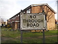 Wooden no through road sign at the entrance to Churchill Close