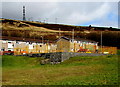 Yellow-fenced play area in the Blaencaerau Estate, Caerau