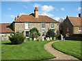 Flint and brick house beside All Saints church