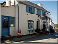 Cleaning windows at the West Down Community Shop