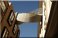 View of the twisted walkway between two buildings on Floral Street