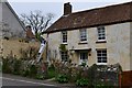 Stogursey: Preparing a cottage for repainting in Church Street