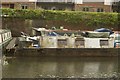 View of a rather dirty narrowboat moored on the River Lea