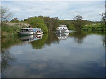 ST6469 : Contrasting boats on the River Avon near Park Corner by Christine Johnstone