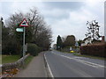 Signpost on the road passing Holy Trinity Church