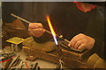 View of a glassblower making jewellery in the crafts marquee in the St Albans Steam and Country Show