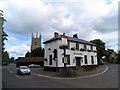 TL1351 : The Anchor pub and All Saints' church, Barford by Bikeboy