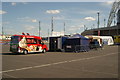 View of an ice cream van and a sweets and waffles stall from the car park on Engineer