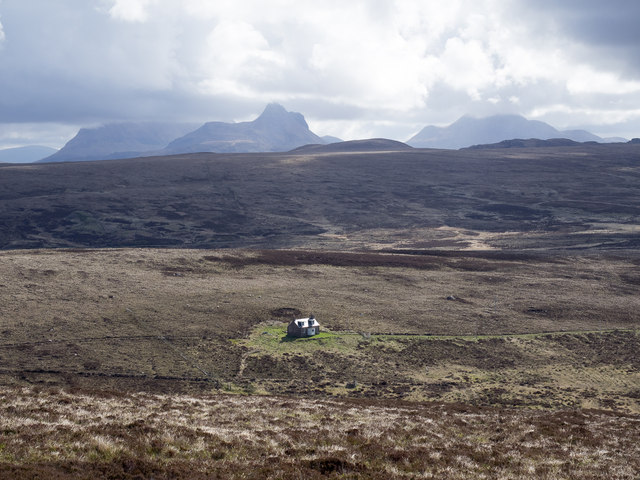Moorland descending towards isolated house