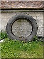 Clunch-built wall (and tractor tyre) at Manor Farm