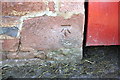 NY6620 : Benchmark on barn at Barrowmoor Farm by Roger Templeman