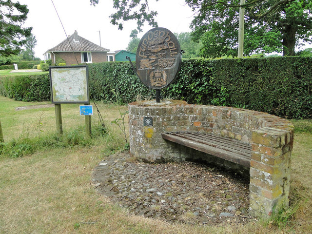 Seat, information board and village sign at Fundenhall