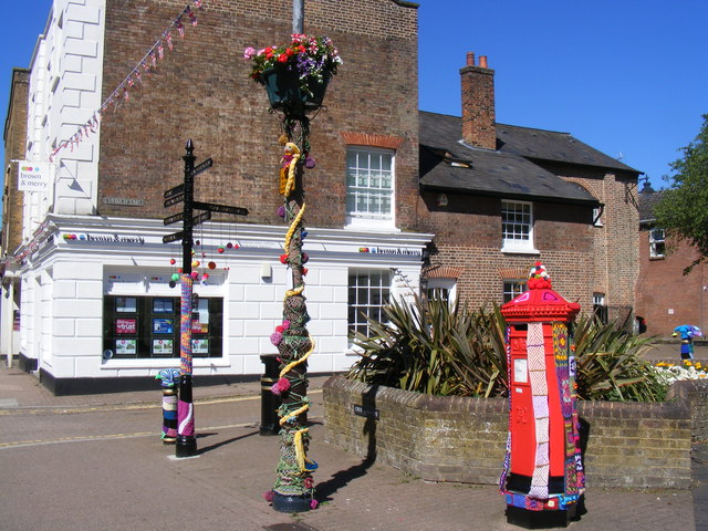 Tring town centre - pillar-box and signpost with knitted decorations