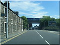 A910 Nicol Street as a Turbostar crosses on bridge