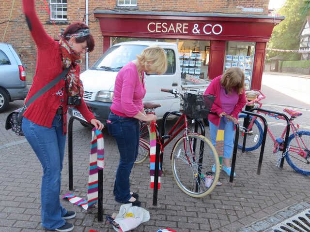Yarn bombing the bicycle rails in Tring Church Square