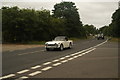 View of a Triumph TR4 passing along London Road as part of the London-Southend Classic Car Run