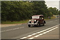 View of an Austin 14 passing along London Road as part of the London-Southend Classic Car Run