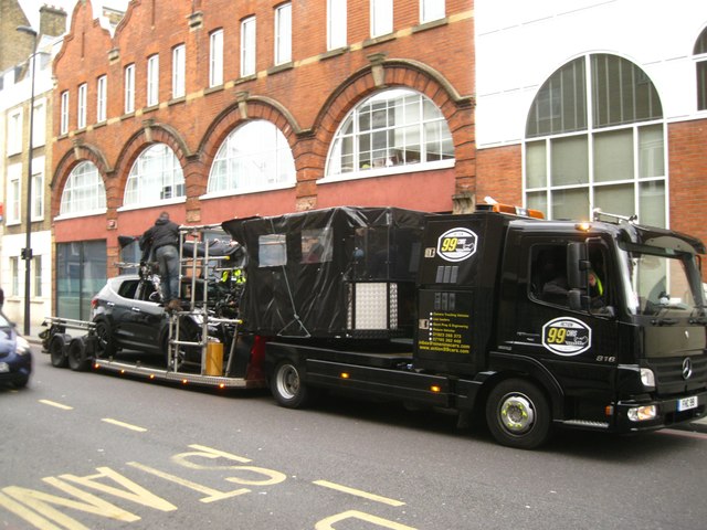 Film crew preparing to shoot a scene in a car, King's Cross Road, London