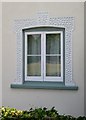 Cottage window with Coade stone decoration