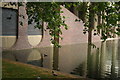 View of The Postern reflected in the water from the area next to the Barbican Estate