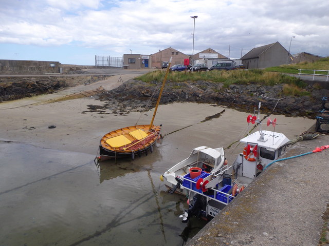 Small boats beached at their moorings in Portsoy New Harbour