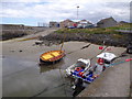 Small boats beached at their moorings in Portsoy New Harbour