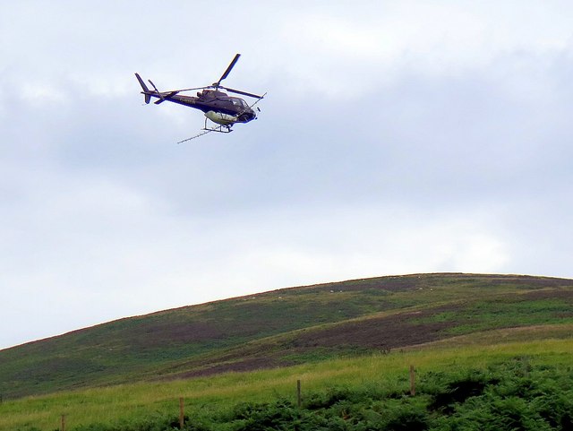 Bracken spraying helicopter near Langleeford