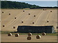 TL0786 : Rolls of straw on the hillsides near Polebrook by Richard Humphrey