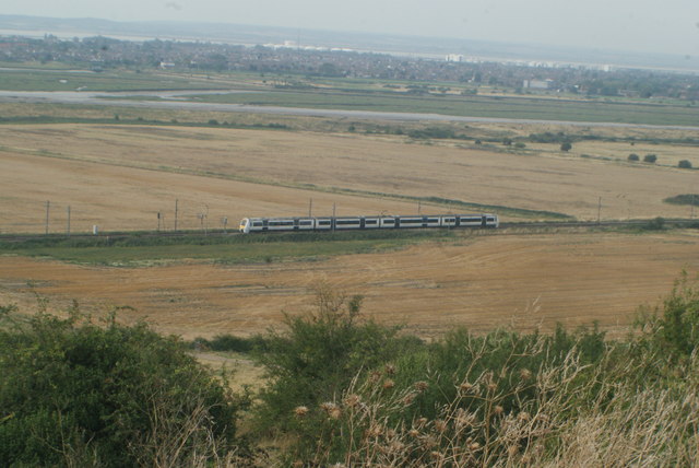 View of a Shoeburyness-bound c2c train crossing the Leigh Marshes from Hadleigh Castle