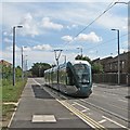 A city-bound tram leaving Meadows Way West