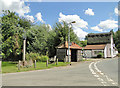 TL7257 : Lidgate village pond, sign, bus stop shelter and stores by Adrian S Pye