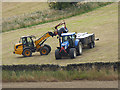 NY9068 : Picking up bales by Oliver Dixon