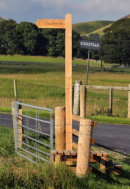 A signpost and stile by the A708 at Kirkstead
