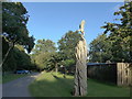 Wooden sculpture within the Woodland Burial Ground