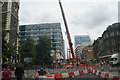 TQ3381 : View of a crane on Aldgate High Street by Robert Lamb