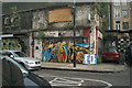 TQ3381 : View of wall art on a run-down retail building on Toynbee Street by Robert Lamb