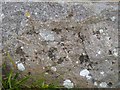 Worn benchmark on limekiln, Caer Bwdy Bay, Pembrokeshire