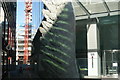 View of stripes from 60 Threadneedle Street reflected onto a sculpture of a feather