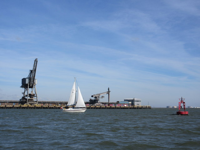 River Medway marker buoy, sailing boat and Kingsnorth Power Station jetty