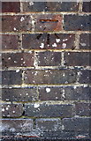 TQ2636 : Benchmark on wall outside #55 Horsham Road by Roger Templeman