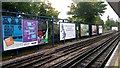 Trackside advertising hoardings at Kilburn station