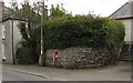 Red postbox in a Helston Road wall, Penryn