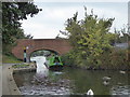 Barge passing under Manor Farm Road bridge on the Paddington Branch of the Grand Union Canal