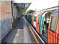 Underground train waiting at Canons Park station